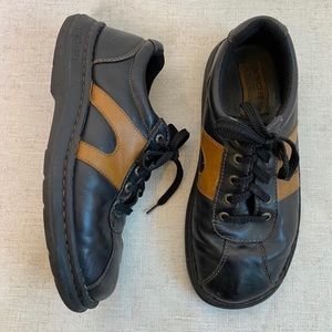 black skechers with muted orange detailing on sides